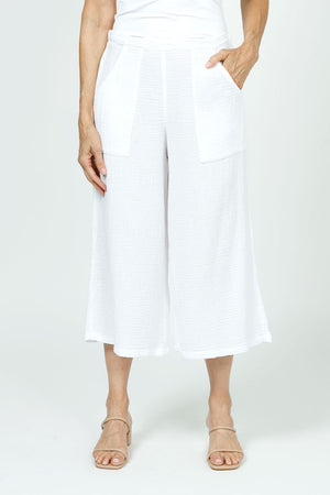 Organic Rags Gauze Pocket Crop in White. Pull on cotton gauze pant with 3/4" contoured flat front waistband, elastic back. Falls straight through the hip, thigh and leg. 2 front pockets. 22" inseam._35729899847880