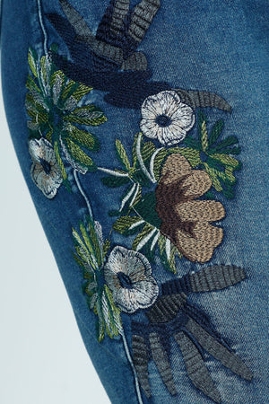 Organic Rags Embroidered  Ankle Jean in Denim.  Medium wash pull on jean with elastic waist.  Floral embroidery on side of right leg.  2 front slash pockets; 2 rear patch pockets.  27 1/2" inseam._52915082330478