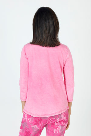 Organic Rags Ruffle Henley in Hot Pink.  Crew neck with split placket. Ruffle trim on 1 side of placket.  3/4 sleeve.  Curved hem.  Relaxed fit._59648072941934