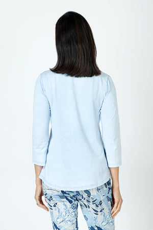 Organic Rags Ruffle Henley in Sky.  Crew neck with split placket. Ruffle trim on 1 side of placket.  3/4 sleeve.  Curved hem.  Relaxed fit._59648072810862