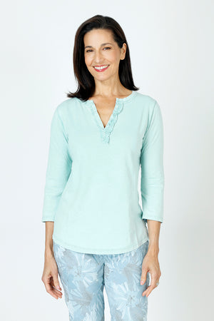 Organic Rags Ruffle Henley in Tiffany, an aqua shade.  Crew neck with split placket. Ruffle trim on 1 side of placket.  3/4 sleeve.  Curved hem.  Relaxed fit._59648072843630