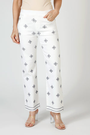 Organic Rags Geometric Embroidered Ankle Jean in White. Blue embroidery in diamond pattern. Pull on denim with elastic waist.  5 pocket styling.  Embroidered double border.  Slightly flared leg.  28" inseam. _59845497586030