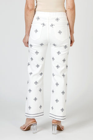 Organic Rags Geometric Embroidered Ankle Jean in White. Blue embroidery in diamond pattern. Pull on denim with elastic waist.  5 pocket styling.  Embroidered double border.  Slightly flared leg.  28" inseam. _59845497618798