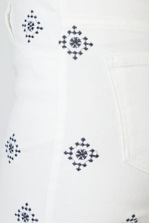 Organic Rags Geometric Embroidered Ankle Jean in White. Blue embroidery in diamond pattern. Pull on denim with elastic waist.  5 pocket styling.  Embroidered double border.  Slightly flared leg.  28" inseam. _59845497651566