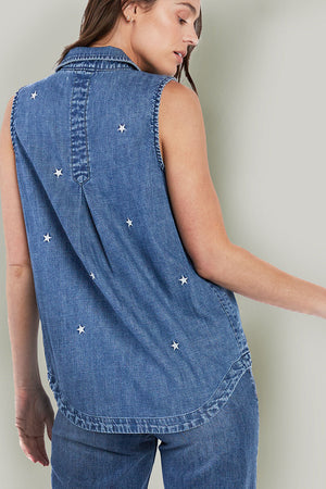 Billy T Scarlet Sleeveless Shirt in Denim. Medium blue pointed collar button down sleeveless shirt with embroidered stars in white. 2 front patch pockets. Inserts at side seams. Banded high low shirt tail hem. Back placket with inverted pleat. Relaxed fit._35798307766472