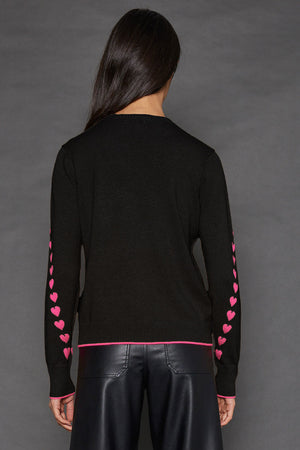 Lisa Todd Love Notes Sweater in Black.  Crew neck long sleeve cotton/cashmere knit.  Pink intarsia knit hearts wrap around sleeves.  Rib trim at neck, hem and cuff.  Pink tipping at hem and cuff.  Relaxed fit._52882964152686