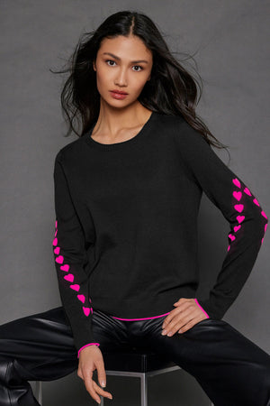 Lisa Todd Love Notes Sweater in Black.  Crew neck long sleeve cotton/cashmere knit.  Pink intarsia knit hearts wrap around sleeves.  Rib trim at neck, hem and cuff.  Pink tipping at hem and cuff.  Relaxed fit._52882964250990