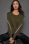 Lisa Todd Love Notes Sweater in Eden, an olive green.  Crew neck long sleeve cotton/cashmere knit.  Lavender intarsia knit hearts wrap around sleeves.  Rib trim at neck, hem and cuff.  Lavender tipping at hem and cuff.  Relaxed fit._t_52882964283758