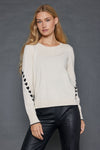 Lisa Todd Love Notes Sweater in Sheepskin.  Crew neck long sleeve cotton/cashmere knit.  Black intarsia knit hearts wrap around sleeves.  Rib trim at neck, hem and cuff.  Black tipping at hem and cuff.  Relaxed fit._t_52882964185454