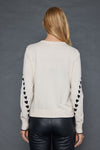 Lisa Todd Love Notes Sweater in Sheepskin.  Crew neck long sleeve cotton/cashmere knit.  Black intarsia knit hearts wrap around sleeves.  Rib trim at neck, hem and cuff.  Black tipping at hem and cuff.  Relaxed fit._t_52882964316526