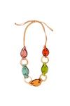 The Bonnie Necklace is a stylish and earth-friendly statement necklace featuring hand-carved beads alternating between solid and open shapes made from tagua nuts linked together on an adjustable tan faux leather cord._t_35790052360392