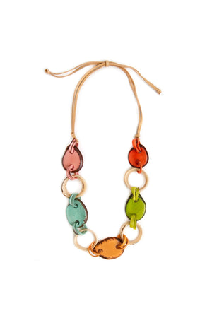 The Bonnie Necklace is a stylish and earth-friendly statement necklace featuring hand-carved beads alternating between solid and open shapes made from tagua nuts linked together on an adjustable tan faux leather cord._35790052360392