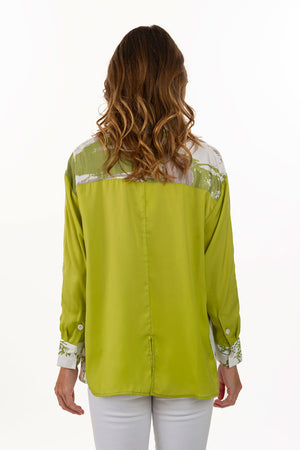 Lemon Grass Palm Hand Printed Blouse. Pointed collasr button down with 1/2 front in solid lime green; other half in abstract palm screen print in beige, lime and white. Solid bracelet length sleeve with palm print cuff. Solid back with print yoke. Relaxed fit._35740000125128