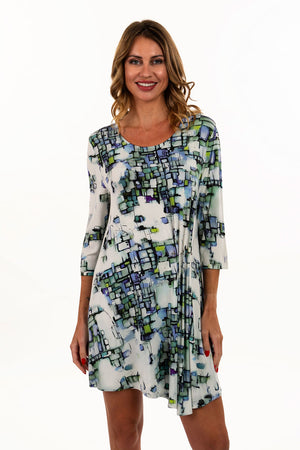 Lemon Grass Round Neck Dress with Metal Pin Detail.  Blue, green and black abstract miniature cubist print on a white background.  Round neck with 3/4 sleeve.  Gathered on left front to create an asymmetric hemline.  Metal pin anchors gathers.  Relaxed fit._35740244967624