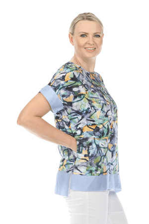 Terra Abstract Floral Top in Blue.  Abstract floral print with solid light blue.  Crew neck, dolman short sleeve top.  Inseam pouch pockets. Inset border of solid blue at hem and cuff. High low hem. Relaxed fit._59705562005870