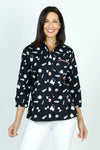 Cali Girls Betty Perfume Print Blouse in Black.  Perfume bottles print in white and pink on a black background.  Pointed collar button down blouse with hidden button placket.  Pink zipper detail above left breast.  3/4 sleeve with fold back cuff.  Back yoke with inverted back pleat.  A line shape.  Relaxed fit._t_59491586048366