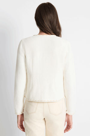 NIC+ZOE Stitch Trim Knit Jacket in Classic Cream.  Crew neck long sleeve textured knit jacket with hook and eye closures at the front.  Long sleeves. Front pockets at the chest with metallic button trim.  Embroidered ribbon trim at edges.  Rear contour darts.  Fitted.  _59575199105390