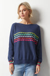 Zaket & Plover Love Struck Sweater in Denim.  Boat neck with long dolman sleeves.  Knit side to side.  Rainbow stripes of intarsia hearts in front.  Rainbow stripes on sleeve cuff.  Rib trim at hem and cuff. Relaxed fit._t_36033738997960