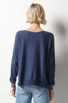 Zaket & Plover Love Struck Sweater in Denim. Boat neck with long dolman sleeves. Knit side to side. Rainbow stripes of intarsia hearts in front. Rainbow stripes on sleeve cuff. Rib trim at hem and cuff. Relaxed fit._t_36033739030728