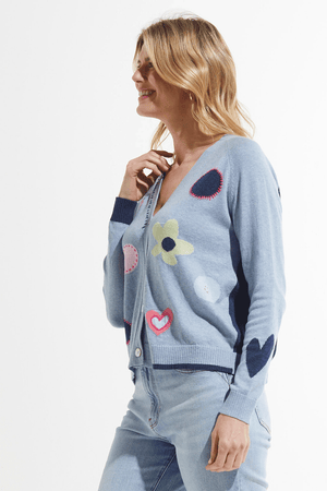 Zaket & Plover Flowers & Spots Cardigan in Jean.  V neck button down cardigan.  Long raglan sleeves.  Intarsia flowers and dots on front with embroidered details.  Contrast tipping.  Light denim front, dark denim back.  Relaxed fit._59640221106542