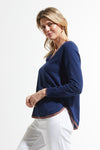 Zaket & Plover Round Bottom V Neck Sweater in Navy.  V neck raglan long sleeve sweater.  Rainbow stripe inset at neckline.  Curved hem with narrow stripe trim.  Contrast color hand stitching on right armhole.  Rib trim at neck and cuff. Rainbow stripe tipping on sleeves. Relaxed fit._t_59493869519214