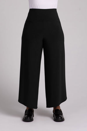 Sympli J Hook Full Leg Pant in Black.  Dropped yoke waist with 2 front slash pockets.  Wide draped leg with curved side hem.  Angled hem.  27" inseam at inner leg. _52918838100334