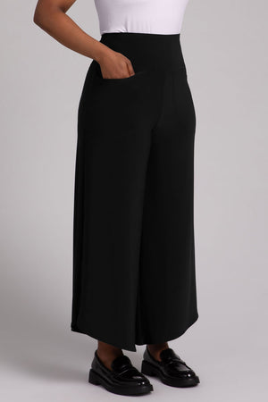 Sympli J Hook Full Leg Pant in Black.  Dropped yoke waist with 2 front slash pockets.  Wide draped leg with curved side hem.  Angled hem.  27" inseam at inner leg.  at inner leg.  _52918838067566