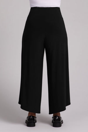 Sympli J Hook Full Leg Pant in Black.  Dropped yoke waist with 2 front slash pockets.  Wide draped leg with curved side hem.  Angled hem.  27" inseam at inner leg. _52918838034798